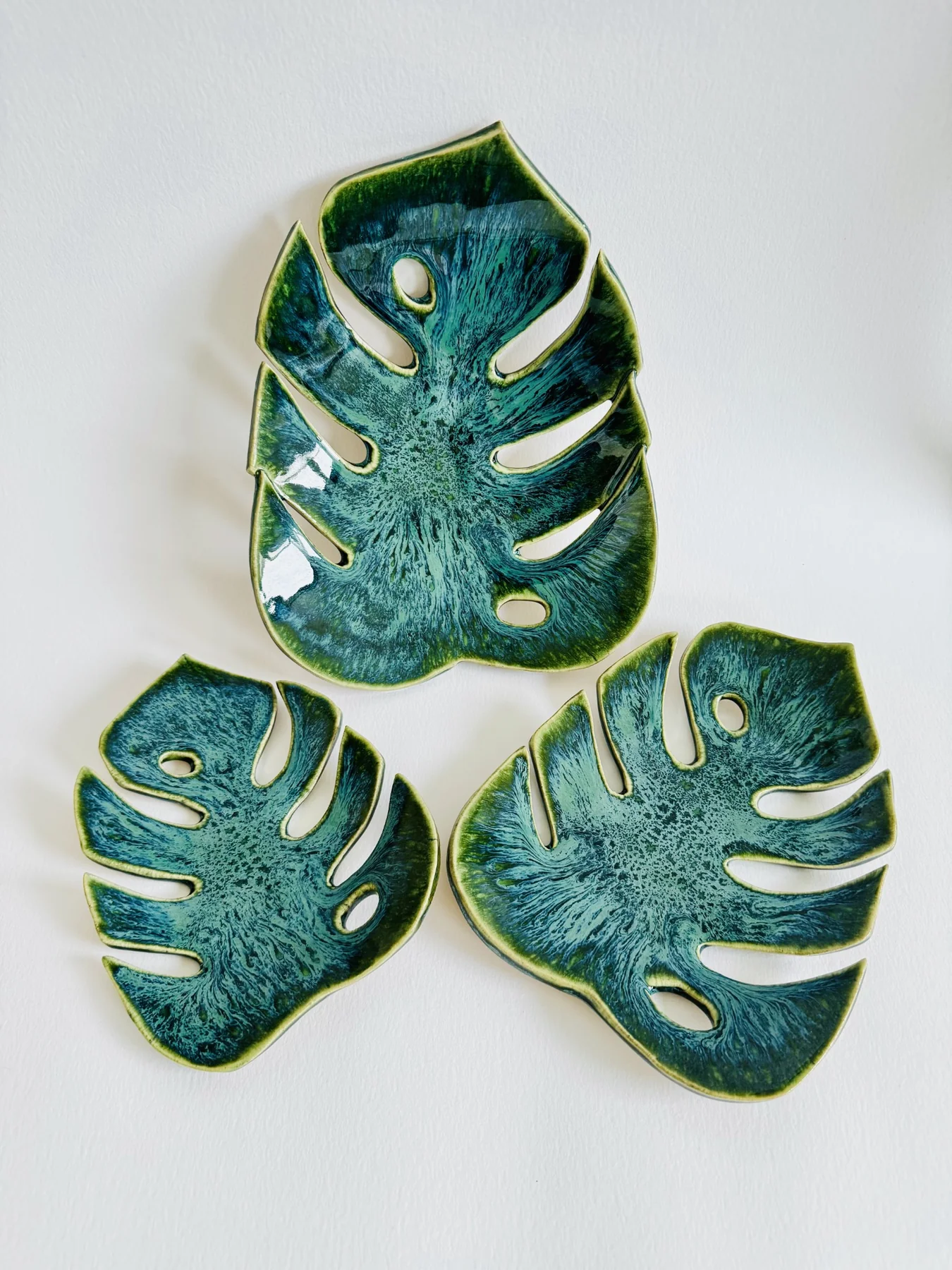 three handmade pottery leaf plates